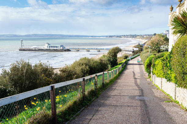 Bournemouth pier, Dorset, UK Bournemouth pier, Dorset, England, view of the blue sea and the road to the beach, selective focus bournemouth england photos stock pictures, royalty-free photos & images