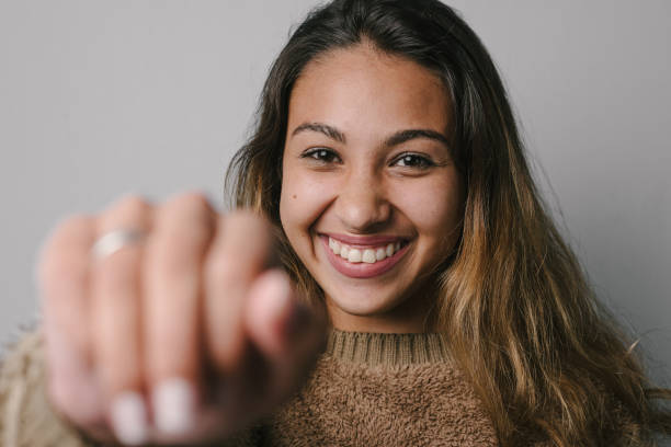 istock Smiling woman touching the camera 1220023069