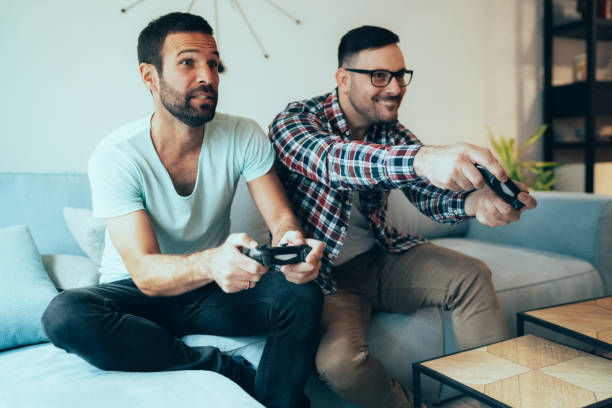 istock Excited friends playing video games 1220023163