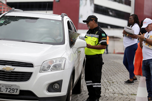 salvador, bahia / brazil - july 9, 2019: Transalvador traffic agent makes educational action with driver near the school in the city of Salvador .