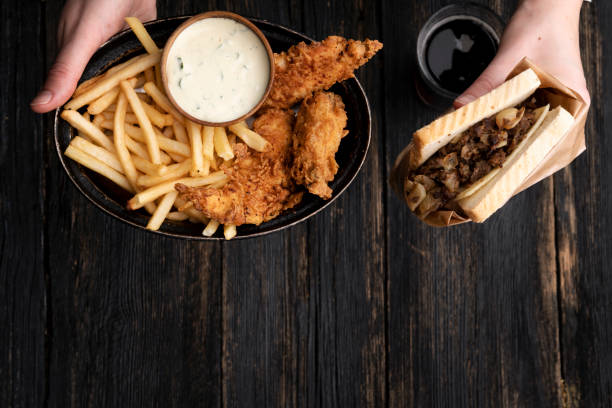istock Fast food over dark wooden background 1220026794