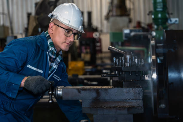 istock industrial background of caucasian mechanics engineer operating lathe machine to make machine part at metal part manufacturing and workshop factory 1220032975