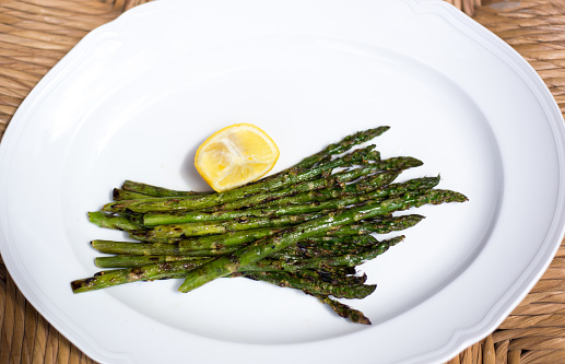 Grilled Asparagus on White Platter with Lemon Slice