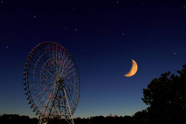 istock Crescent moon rising over the Ferris Wheel 1220036003