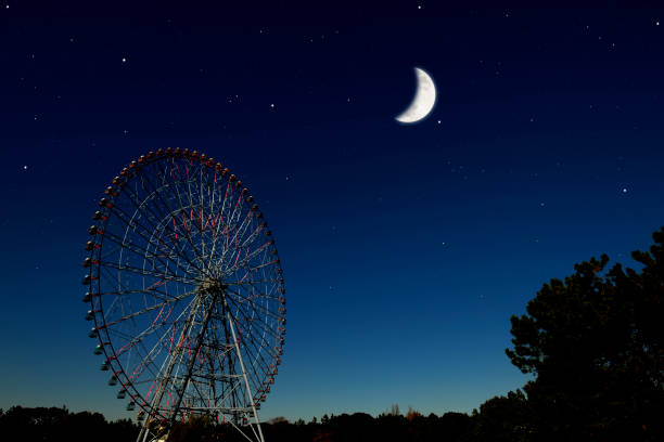 istock Crescent moon rising over the Ferris Wheel 1220036005