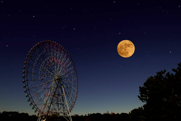 istock Full moon rising over the Ferris Wheel 1220036006