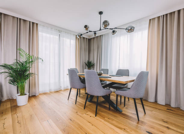 istock Dining room with wooden table and floor in modern apartment. 1220036863