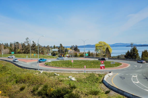 Patricia Bay Highway Roundabout Victoria, Canada - April 13, 2020. Vehicles drive on one of three roundabouts that make up the overpass connecting downtown Victoria with the International Airport. saanich peninsula photos stock pictures, royalty-free photos & images