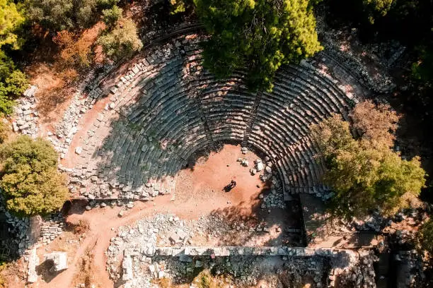 Photo of Top view of the ruins of an amphitheater near the old town of Fazelis. Beautiful park on the Mediterranean coast. Top view of the reserve. tourist attraction and top places in Turkey