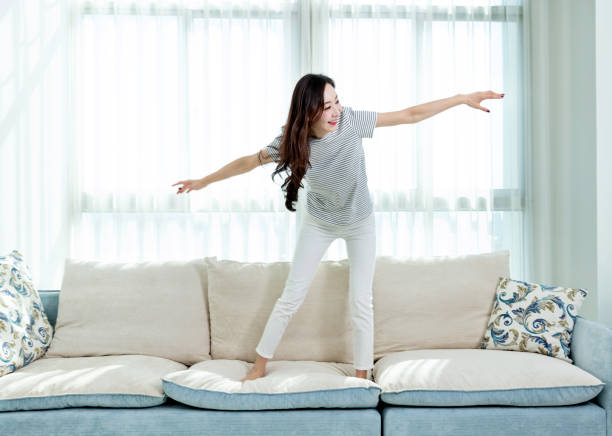 istock Woman dancing on the sofa 1220038493