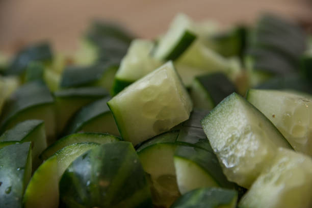 istock Chopped Cucumber Closeup on Chopping Board 1220039419