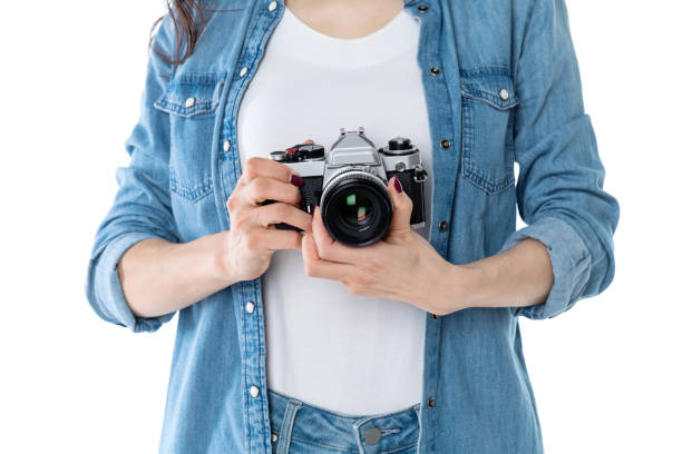istock Woman hand holding a SLR camera on white background 1220039570