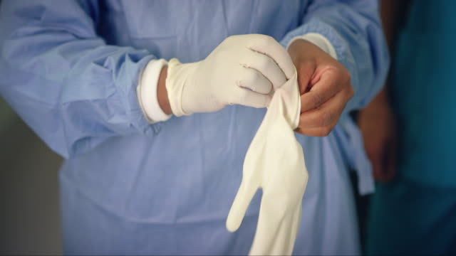CU Female Medic Put On Surgical Gloves