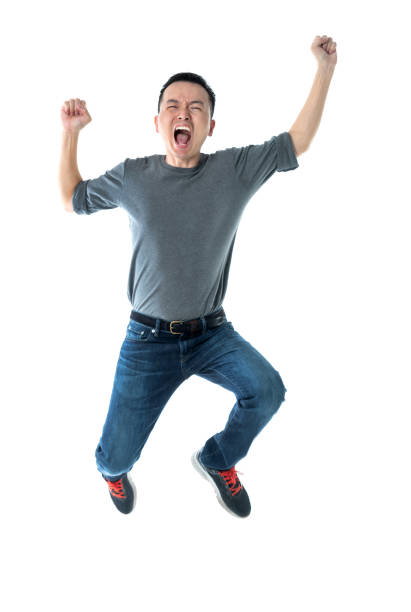istock Excited man jumping on white background 1220045735