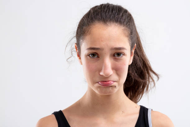 istock Sulky miserable young woman pouting her lips 1220047481