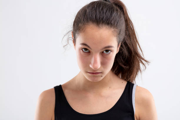 istock Sulky angry young woman glowering at camera 1220047502