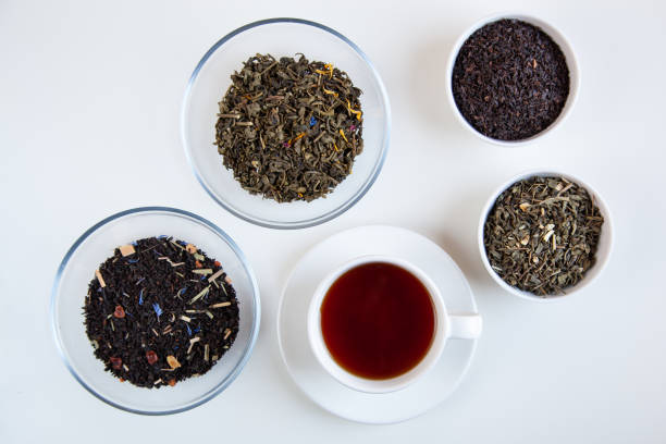 istock Assortment of dry tea in round bowls on a white background. 1220047816