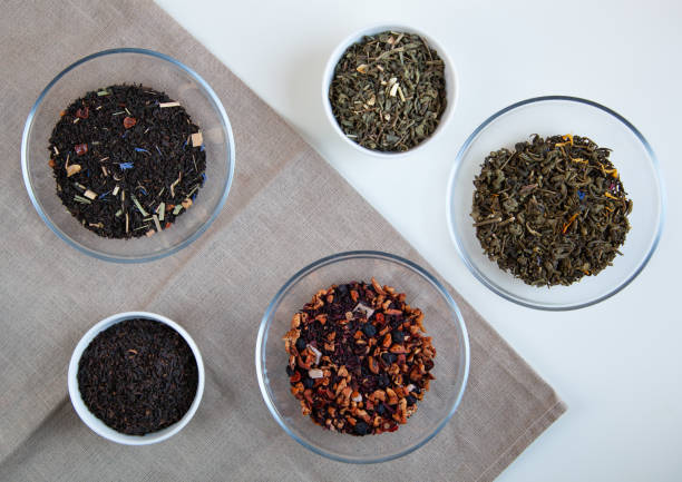 istock Assortment of dry tea in round bowls on a white background. 1220047828
