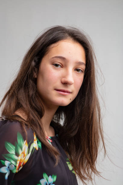istock Thoughtful young woman looking quietly at camera 1220047841