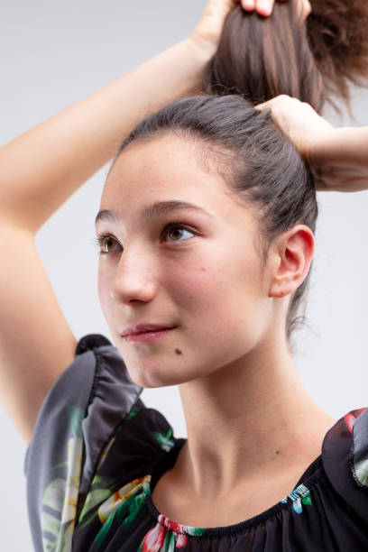 istock Young woman putting her hair into a ponytail 1220047857