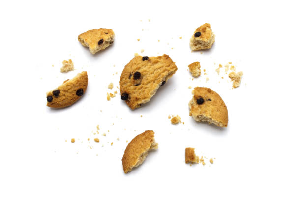 istock Chocolate chip cookies and crumble cracks isolated on white background. Sweet biscuits delicious and crunchy homemade pastry. 1220051419