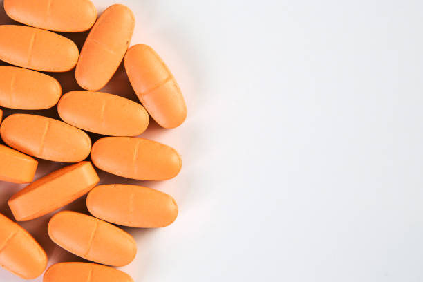 istock Orange pills, prescription drugs on white background. Copy space. 1220054565