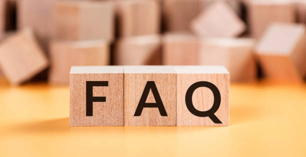 istock Wooden blocks with word FAQ on yellow baclground. Frequently asked question concept 1220054572
