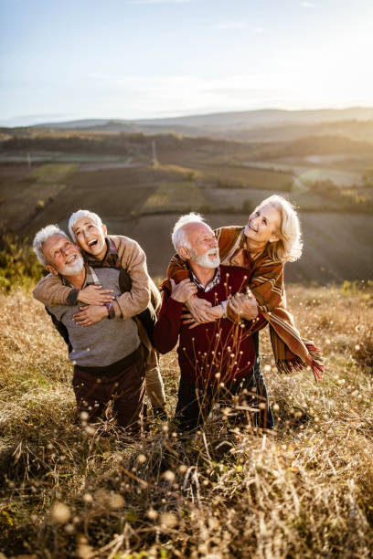 istock Happy embraced mature couples spending an autumn day in a meadow. 1220055679