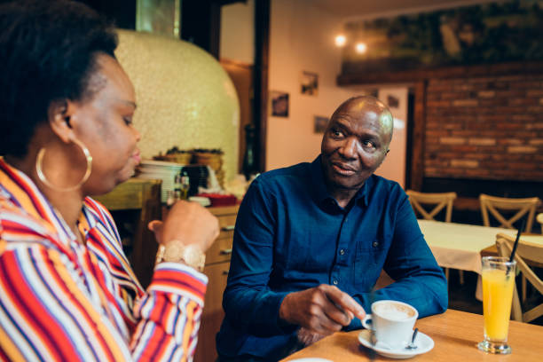 istock Mature  African  - American couple enjoying coffee before ordering dinner 1220055764
