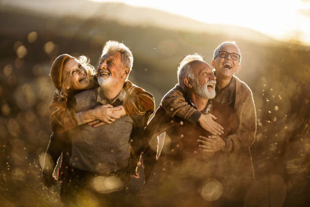 istock Happy mature couples having fun in autumn day. 1220055856