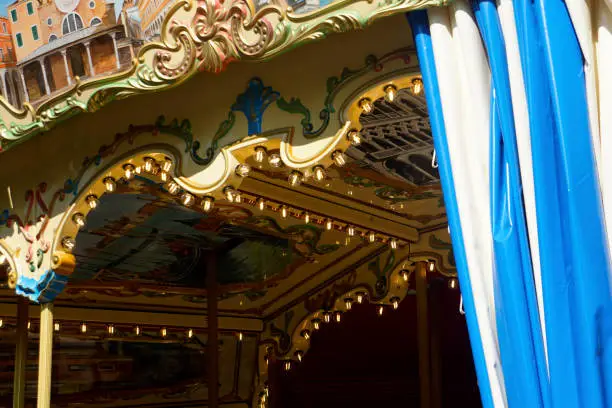 Photo of Details of a traditional Venetian carousel at the funfair.Carousel, traditional fairground ride.