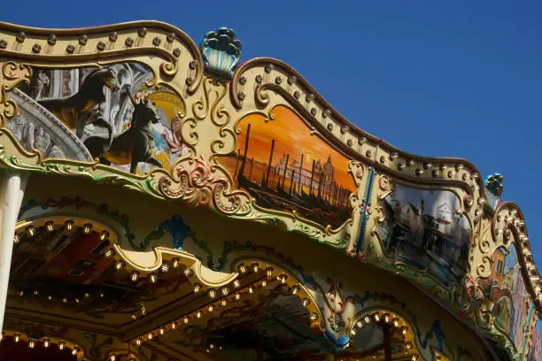 Photo of Details of a traditional Venetian carousel at the funfair.Carousel, traditional fairground ride.