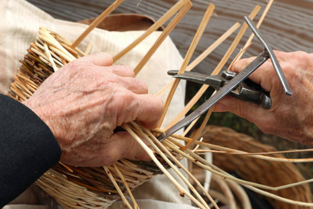 istock hands of senior craftsman worker while creating a wicker basket 1220058318