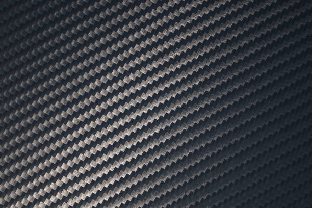 istock Close up of grey diagonal oriented woven carbon fibre sheet surface. 1220059531