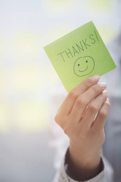 istock Woman holding sticky note with Thanks text 1220060158