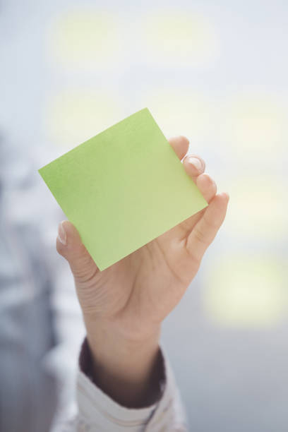 istock Woman holding sticky note with emplty space 1220060165