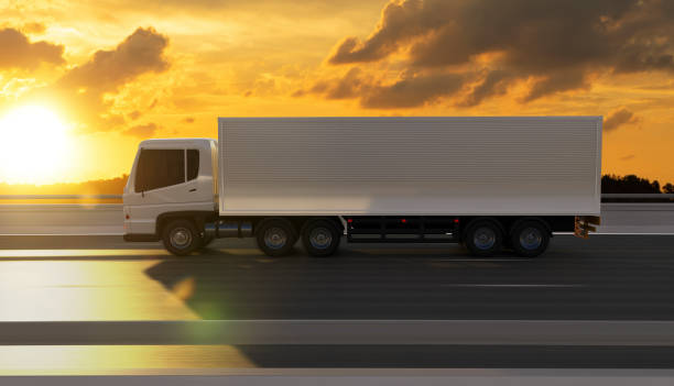 istock Side view angle of cargo truck on the road at sunset 1220060572
