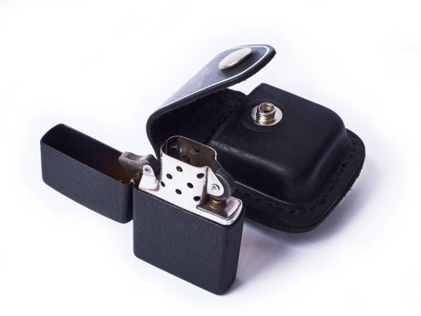 istock Metal lighter and leather case isolated on white 1220061684