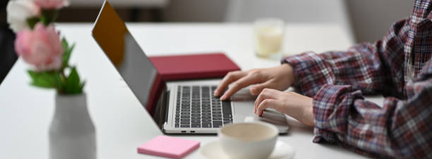 istock Side view of female freelancer typing on laptop in minimal workspace 1220061984