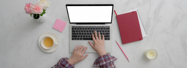 istock Top view of young female freelancer working on her project with blank screen tablet 1220062043