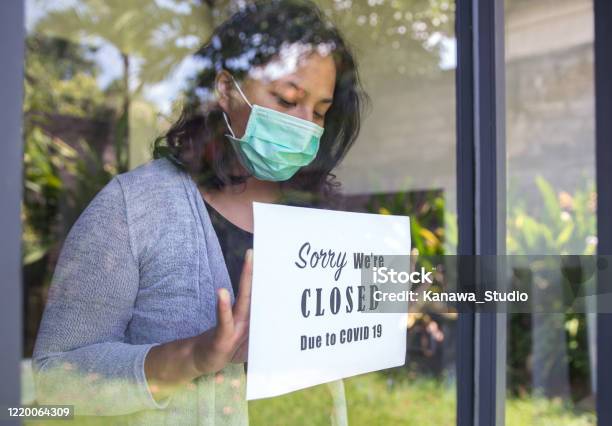 Asian Entrepreneur Closing Business Due To Covid 19 Outbreak Stock Photo - Download Image Now
