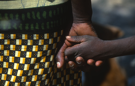Girl shakes hands with her mother in the Cunene Region in southern Angola