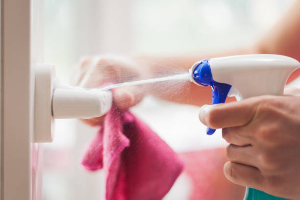 istock Woman hands cleaning, disinfecting door handle. 1220066778