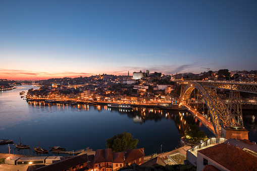 Panorama of city Porto after sunset with river Duoro and historic bridge Ponte Dom Luis I, Portugal