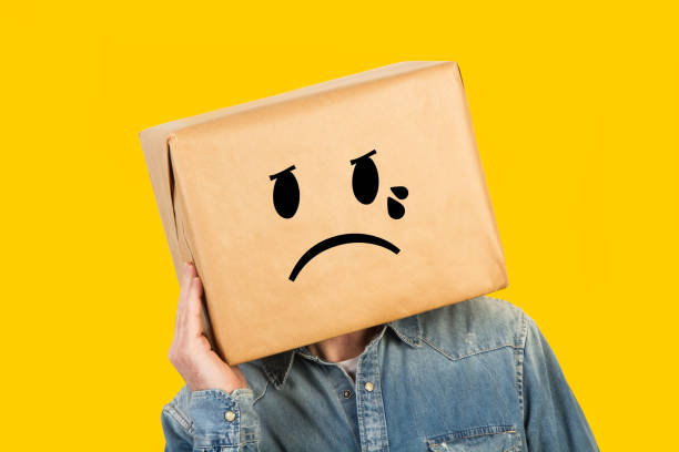 istock Man with his head in a box and crying gesture drawn on it 1220067033