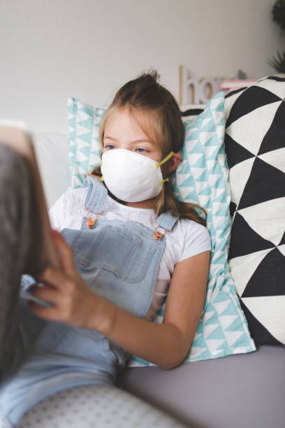 istock young girl with white protective mask at home in her room in quarantine 1220067102