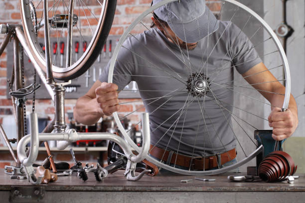 istock man repair the vintage bicycle in garage workshop on the workbench with tools, diy concept 1220067280