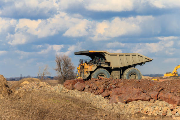 istock Huge yellow mining dump truck working in iron ore quarry. Mining industry 1220068243