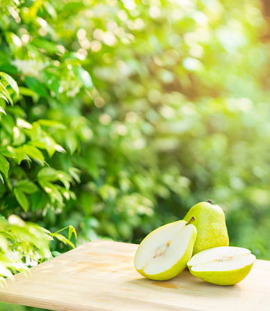 Fresh pears on the brown wooden table in garden,Fresh pears. Green pears in the farm on natural background
