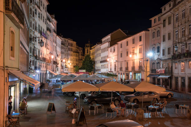 Praca do Comercio in Coimbra during night, Portugal Coffee bar at square Praca do Comercio in city Coimbra during night, Portugal coimbra city stock pictures, royalty-free photos & images